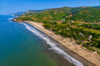 Bordi Beach tourism aerial view in Maharashtra with Arabian Sea coastline and scenic coconut tree landscape